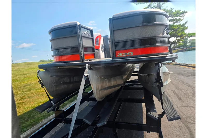 Slide: The Image of 2023 Crest Caribbean RS 230 pontoon boat on trailer by a lakeside. - 6