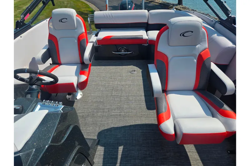 Slide: The Image of 2023 Crest Caribbean RS 230 boat interior with red and gray seating, steering wheel, and dashboard. - 22