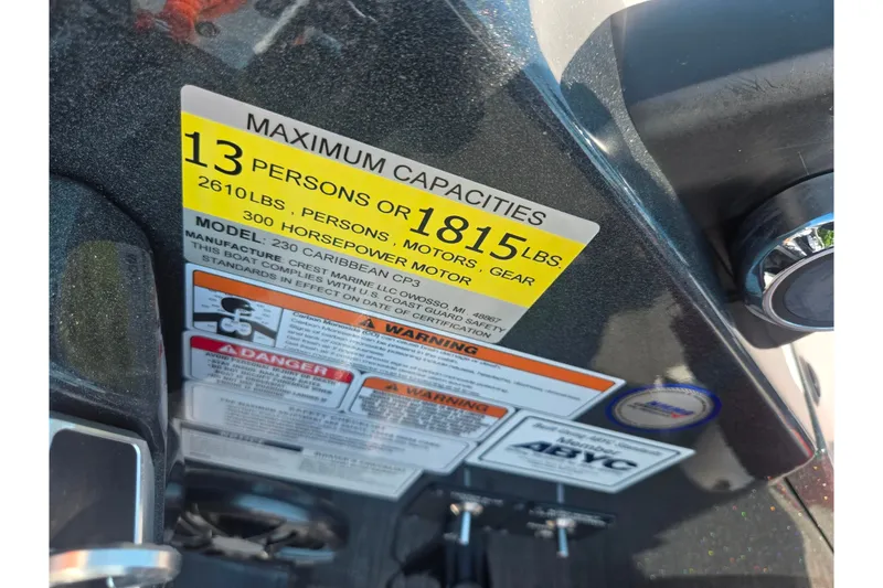 Slide: The Image of Capacity label on 2023 Crest Caribbean RS 230 boat, showing limits and safety warnings. - 13