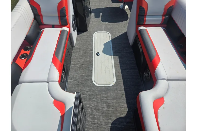 Slide: The Image of 2023 Crest Caribbean RS 230 boat interior with red and gray seating and carpeted floor. - 19