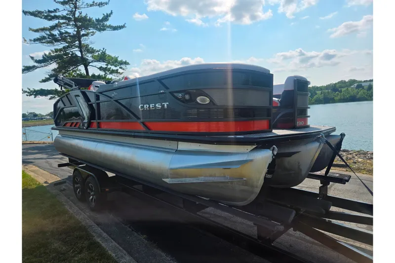 Slide: The Image of 2023 Crest Caribbean RS 230 pontoon boat on trailer by a lakeside. - 8