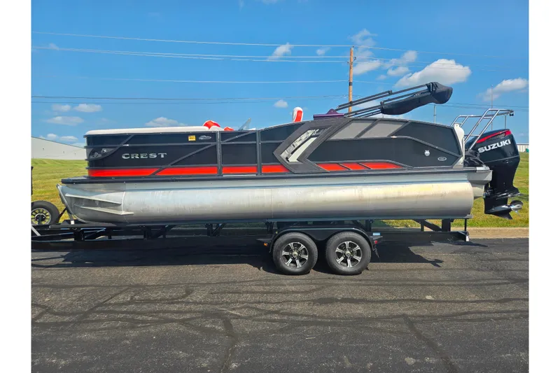 Slide: The Image of 2023 Crest Caribbean RS 230 pontoon boat on trailer, featuring sleek design and Suzuki engine. - 4