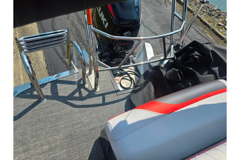 Slide: The Image of 2023 Crest Caribbean RS 230 boat deck with Suzuki engine and seating. - 25