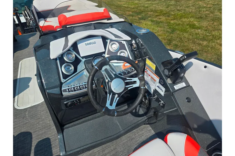 Slide: The Image of 2023 Crest Caribbean RS 230 boat dashboard with steering wheel and control panel. - 12