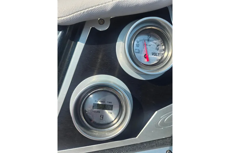Slide: The Image of Dashboard gauges of 2023 Crest Caribbean RS 230 boat, showing voltage and elapsed time. - 10