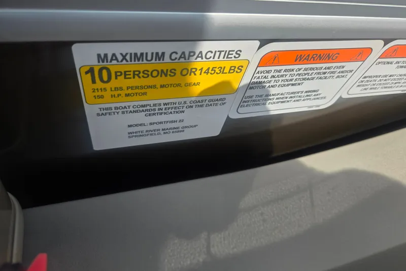 Slide: The Image of 2023 Sun Tracker SportFish 22 DLX capacity label, showing maximum 10 persons or 1453 lbs. - 14