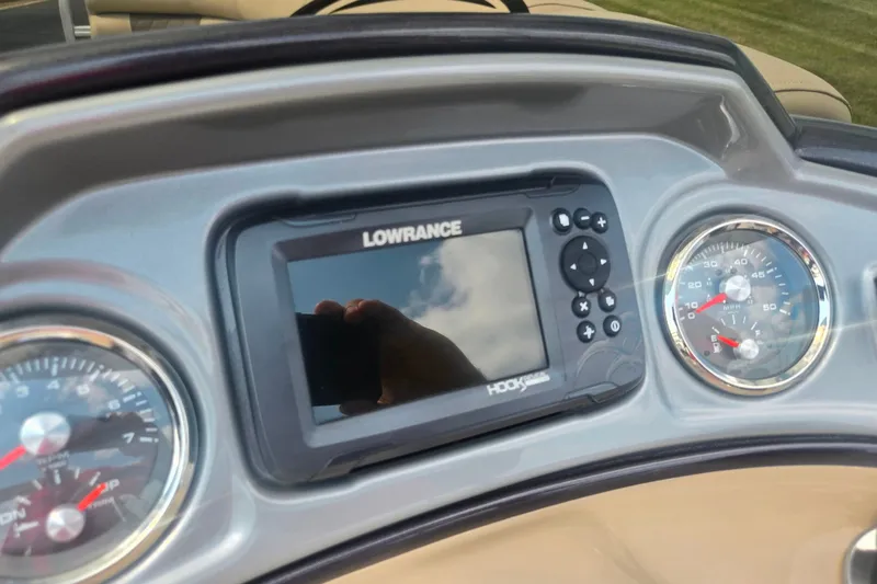 Slide: The Image of Dashboard of 2023 Sun Tracker SportFish 22 DLX with Lowrance Hook display and gauges. - 24