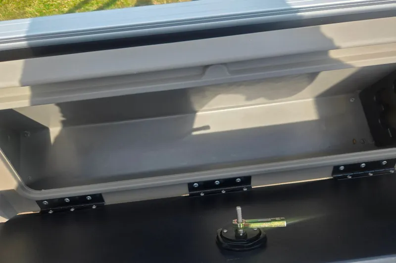 Slide: The Image of Storage compartment of 2023 Sun Tracker SportFish 22 DLX boat, open and empty. - 17