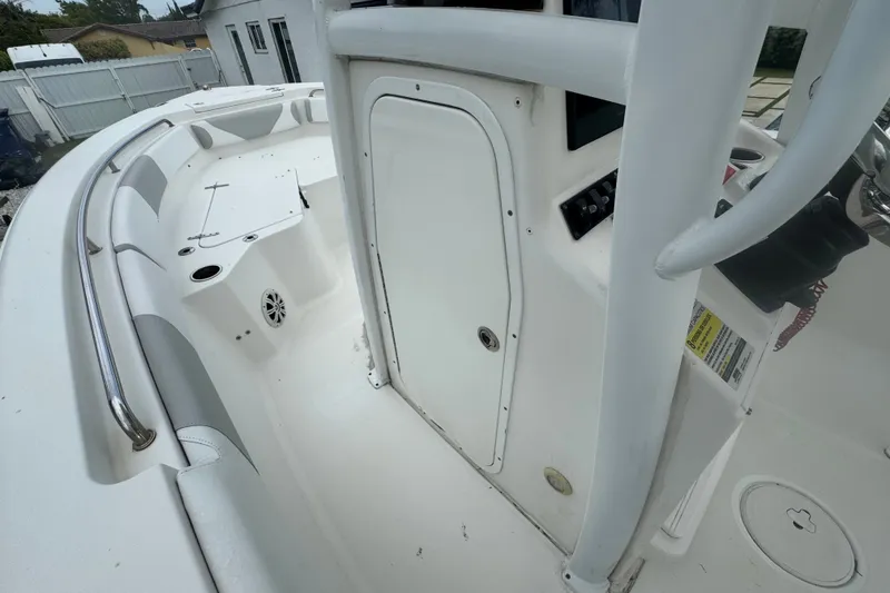 Slide: The Image of 2015 Sea Hunt Ultra 235SE boat interior, featuring white seating and control panel. - 26