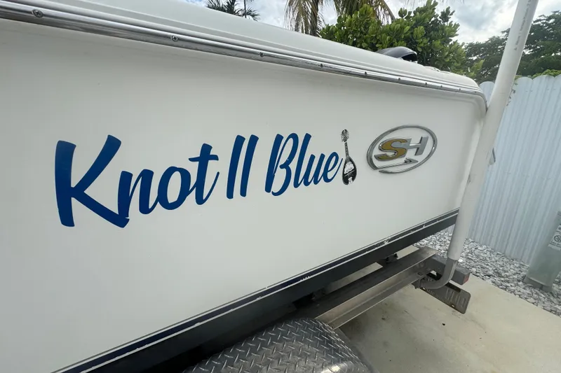 Slide: The Image of 2015 Sea Hunt Ultra 235SE boat with "Knot II Blue" name on the side. - 50