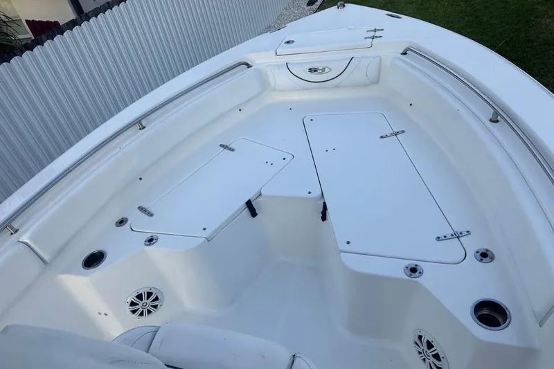 Slide: The Image of 2015 Sea Hunt Ultra 235SE boat interior with storage compartments and seating. - 31