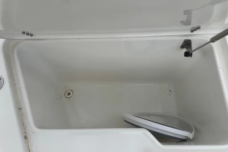 Slide: The Image of Open storage compartment on a 2015 Sea Hunt Ultra 235SE boat. - 34