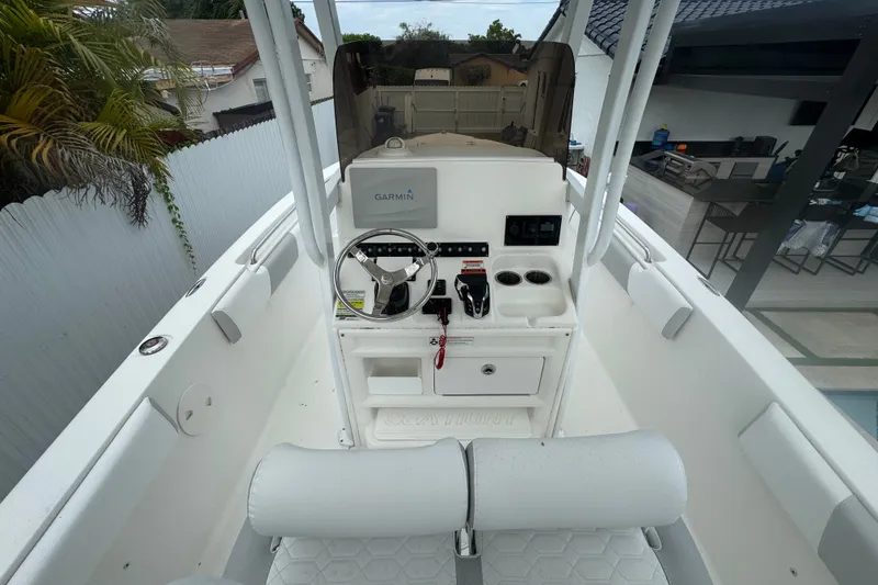 Slide: The Image of 2015 Sea Hunt Ultra 235SE boat cockpit with Garmin navigation system and steering wheel. - 18