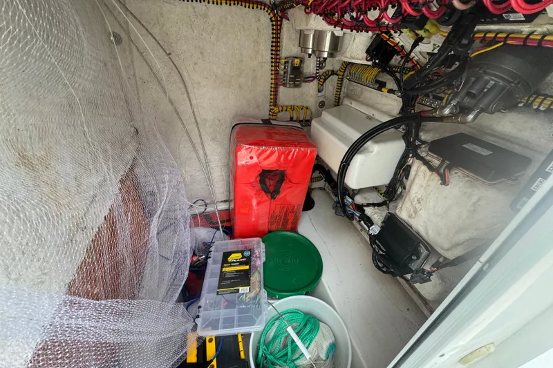 Slide: The Image of Interior of a 2015 Sea Hunt Ultra 235SE boat with wiring and storage items. - 28