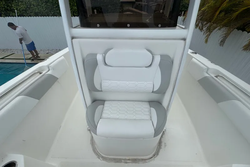Slide: The Image of 2015 Sea Hunt Ultra 235SE boat interior with white cushioned seating. - 42