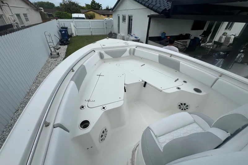 Slide: The Image of 2015 Sea Hunt Ultra 235SE boat interior with seating and storage compartments. - 30