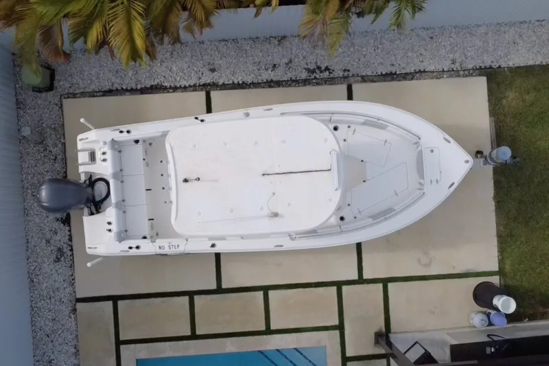 Slide: The Image of Overhead view of a 2015 Sea Hunt Ultra 235SE boat on a patio. - 46