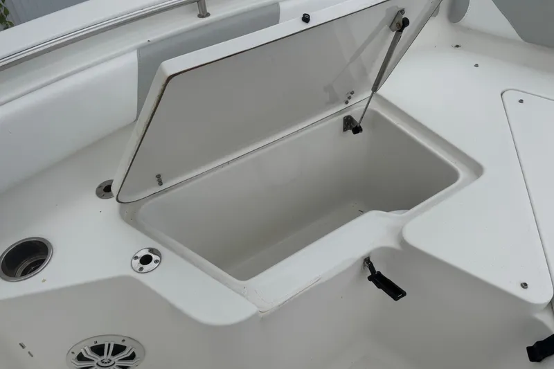 Slide: The Image of Open storage compartment on a 2015 Sea Hunt Ultra 235SE boat deck. - 36