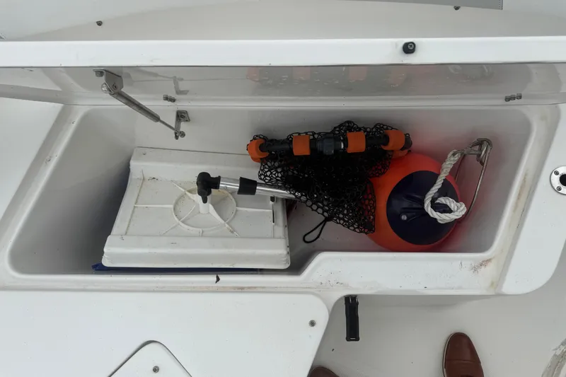 Slide: The Image of Storage compartment on a 2015 Sea Hunt Ultra 235SE boat with marine equipment. - 37