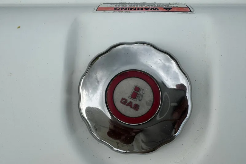 Slide: The Image of Chrome gas cap on 2015 Sea Hunt Ultra 235SE boat with warning label. - 51