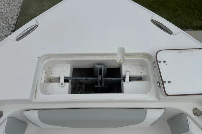 Slide: The Image of Anchor storage compartment on a 2015 Sea Hunt Ultra 235SE boat deck. - 33