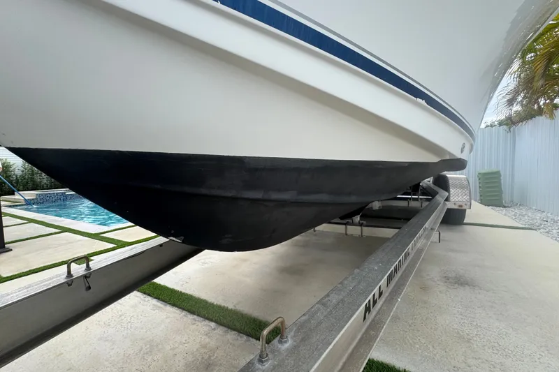 Slide: The Image of 2015 Sea Hunt Ultra 235SE boat on trailer near poolside. - 44