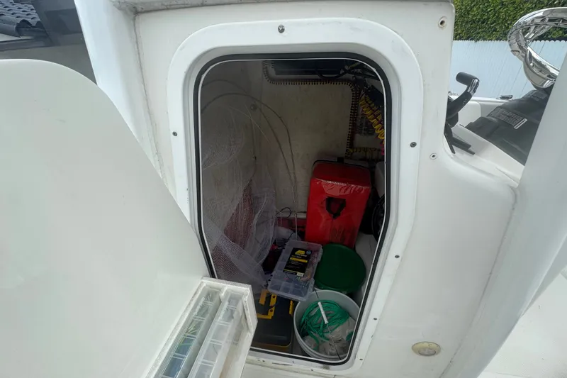 Slide: The Image of Storage compartment of a 2015 Sea Hunt Ultra 235SE boat with fishing gear and supplies. - 27