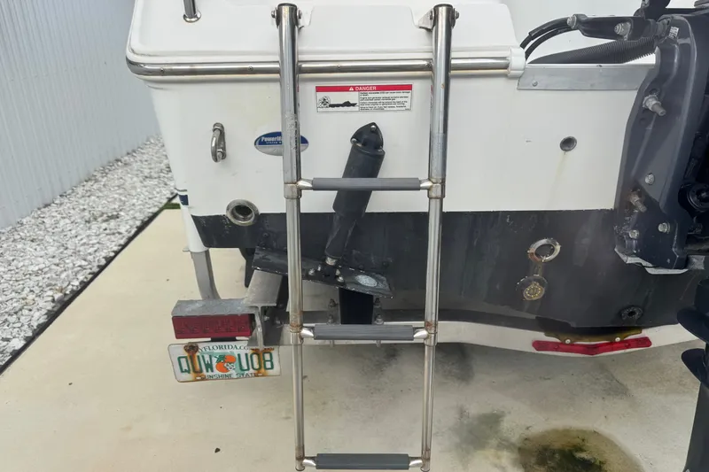 Slide: The Image of Rear view of 2015 Sea Hunt Ultra 235SE boat with ladder and Florida license plate. - 48