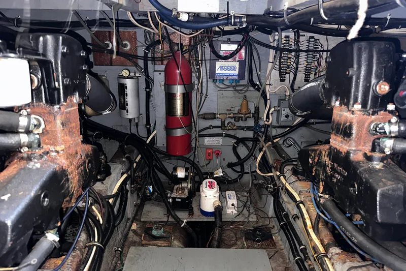 Slide: The Image of Engine room of 1984 Chris-Craft 381 Catalina, showcasing mechanical components and wiring. - 38