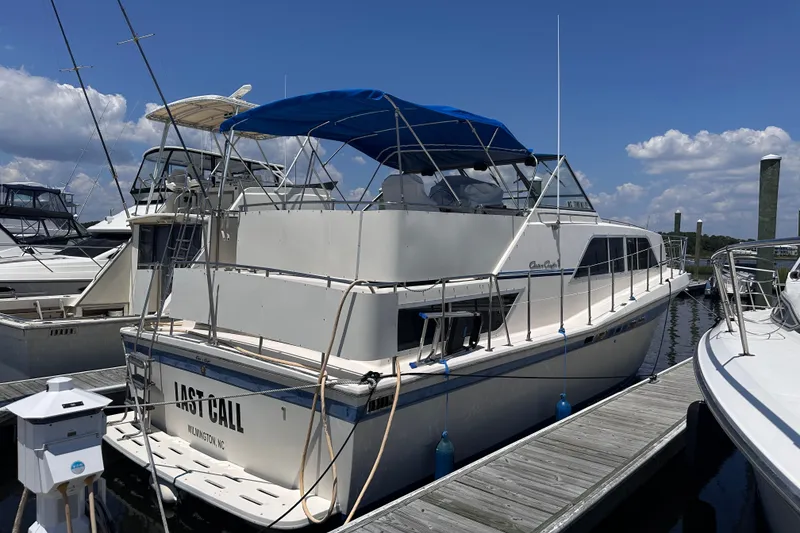 Slide: The Image of 1984 Chris-Craft 381 Catalina docked, featuring blue canopy and sleek design. - 2