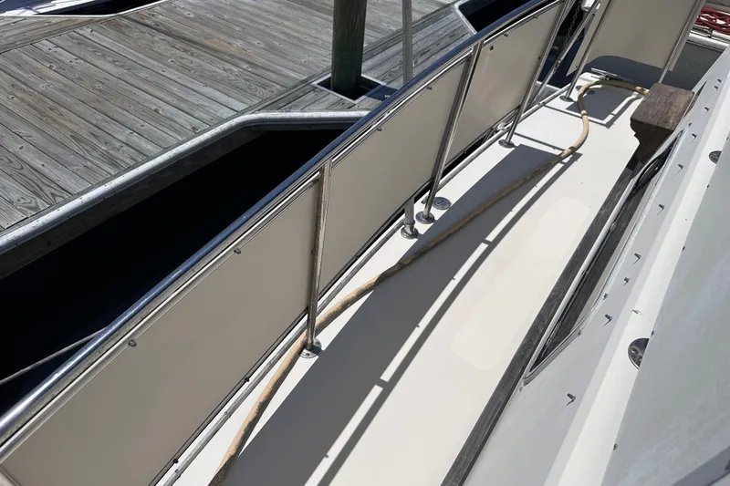 Slide: The Image of 1984 Chris-Craft 381 Catalina yacht deck with railing and dock view. - 8