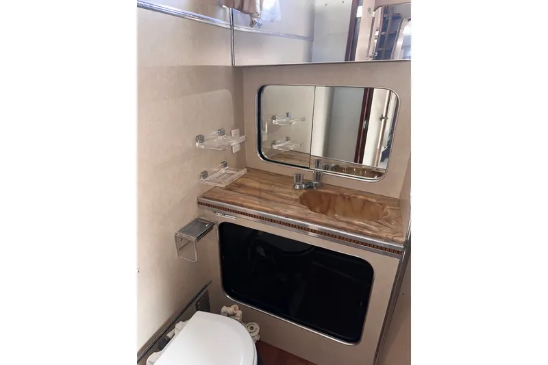 Slide: The Image of 1984 Chris-Craft 381 Catalina bathroom with sink, mirror, and toilet. - 24