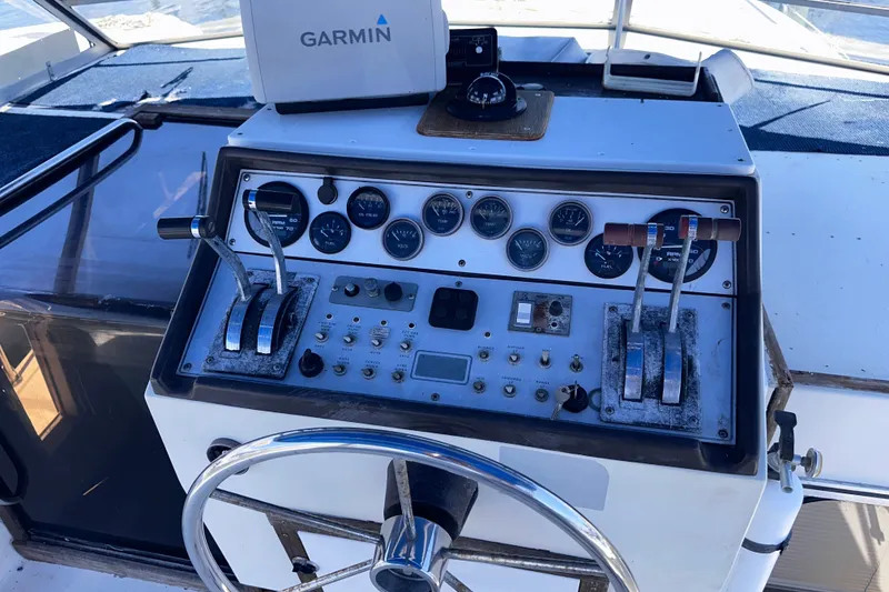 Slide: The Image of 1984 Chris-Craft 381 Catalina boat dashboard with Garmin navigation system and control panel. - 13