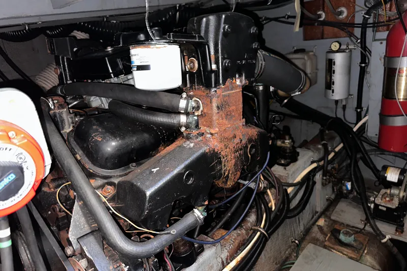 Slide: The Image of Engine room of a 1984 Chris-Craft 381 Catalina, showing mechanical components and wiring. - 37