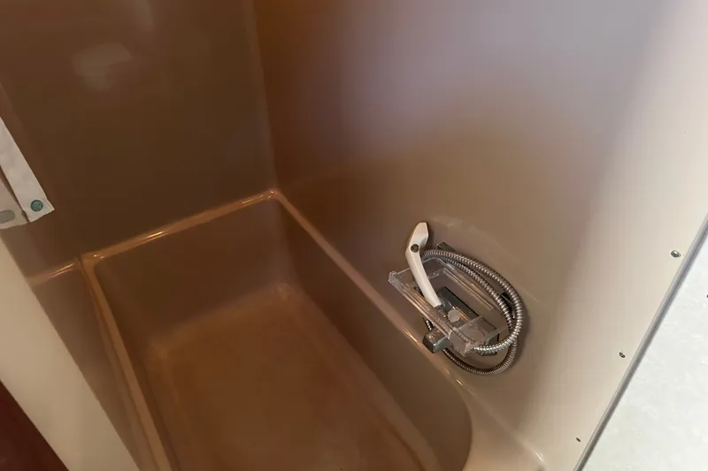 Slide: The Image of Shower area in 1984 Chris-Craft 381 Catalina boat, featuring a handheld showerhead. - 33