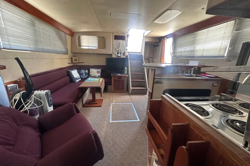 Slide: The Image of Interior of 1984 Chris-Craft 381 Catalina yacht with cozy seating and kitchen area. - 27
