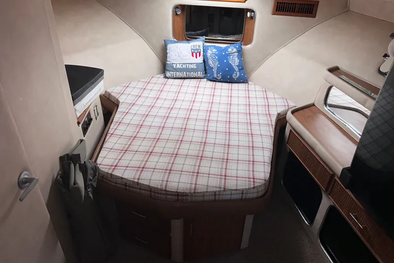 Slide: The Image of Cozy cabin interior of 1984 Chris-Craft 381 Catalina with plaid bedding and decorative pillows. - 21