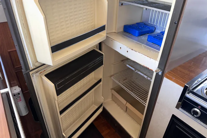 Slide: The Image of 1984 Chris-Craft 381 Catalina refrigerator interior with shelves and ice packs. - 18