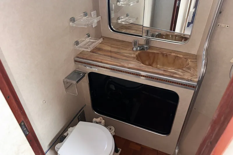 Slide: The Image of 1984 Chris-Craft 381 Catalina bathroom with sink, mirror, and toilet. - 22