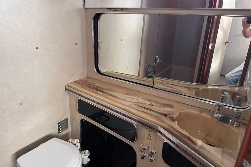 Slide: The Image of 1984 Chris-Craft 381 Catalina bathroom with mirror, sink, and toilet. - 32