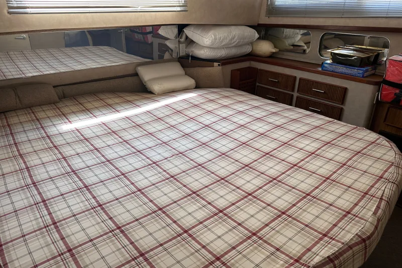 Slide: The Image of Cozy bedroom interior of 1984 Chris-Craft 381 Catalina yacht with plaid bedding. - 31