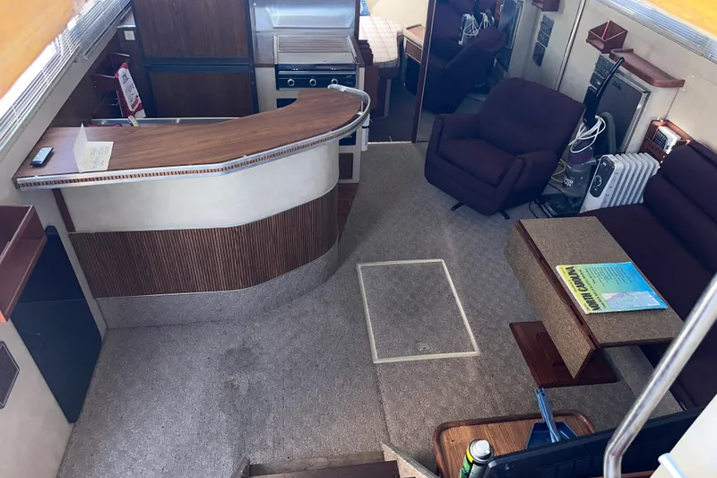 Slide: The Image of Interior of 1984 Chris-Craft 381 Catalina yacht with cozy seating and kitchenette. - 14