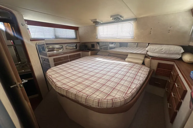Slide: The Image of Interior of 1984 Chris-Craft 381 Catalina with cozy bed and wooden cabinetry. - 29