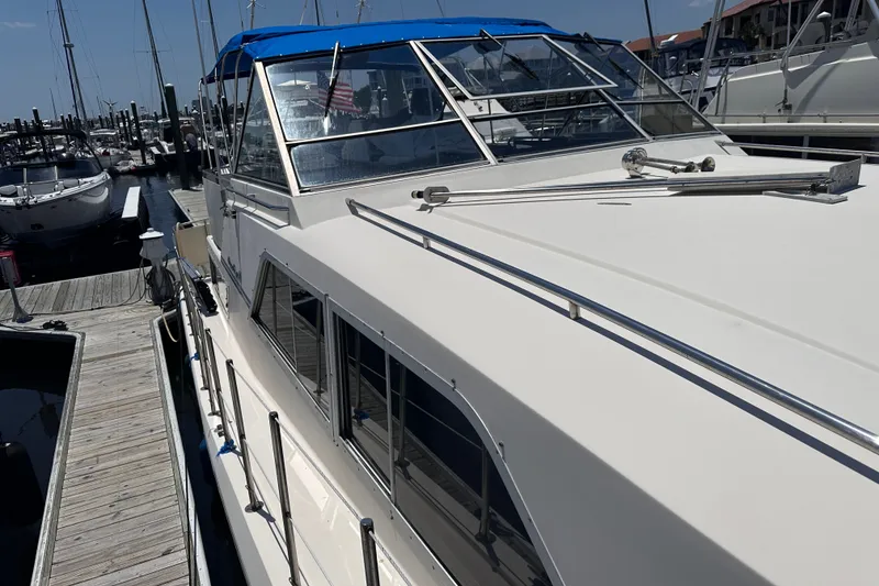 Slide: The Image of 1984 Chris-Craft 381 Catalina yacht docked at marina with blue canopy. - 7