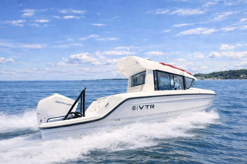 Slide: The Image of 2026 Cruisers Yachts 38 VTR cruising on open water under a clear blue sky. - 1