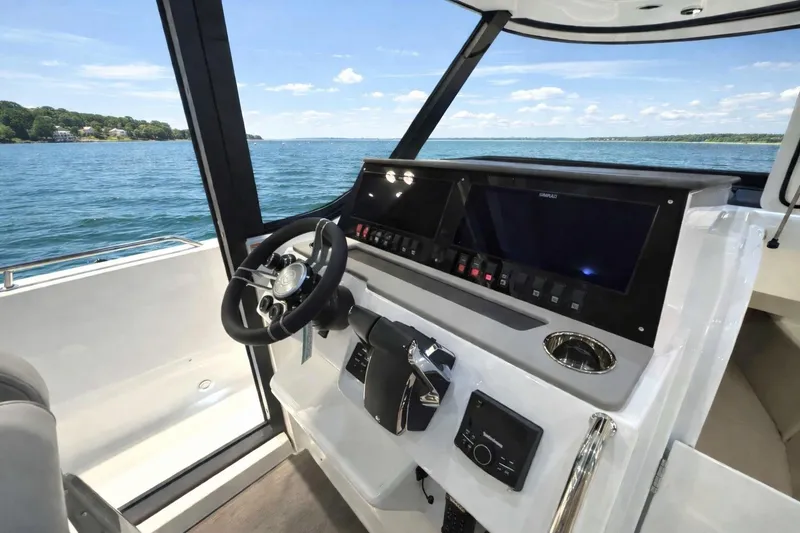 Slide: The Image of 2026 Cruisers Yachts 38 VTR helm with modern controls and scenic water view. - 9