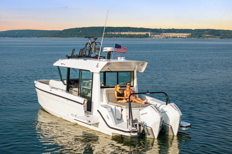 Slide: The Image of 2026 Cruisers Yachts 38 VTR on serene lake with passengers enjoying the view. - 20