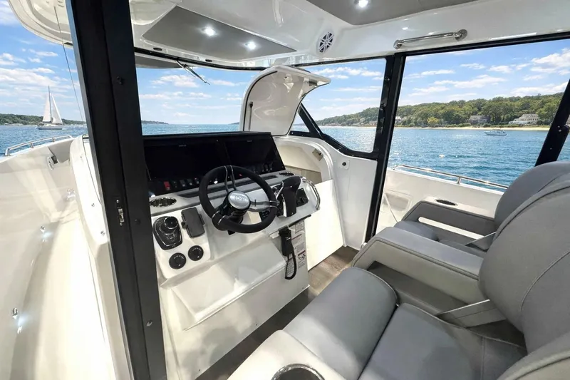Slide: The Image of 2026 Cruisers Yachts 38 VTR helm with modern controls, overlooking scenic waters. - 8