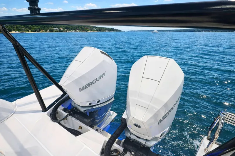 Slide: The Image of Twin Mercury outboard engines on 2026 Cruisers Yachts 38 VTR, cruising on a sunny lake. - 4