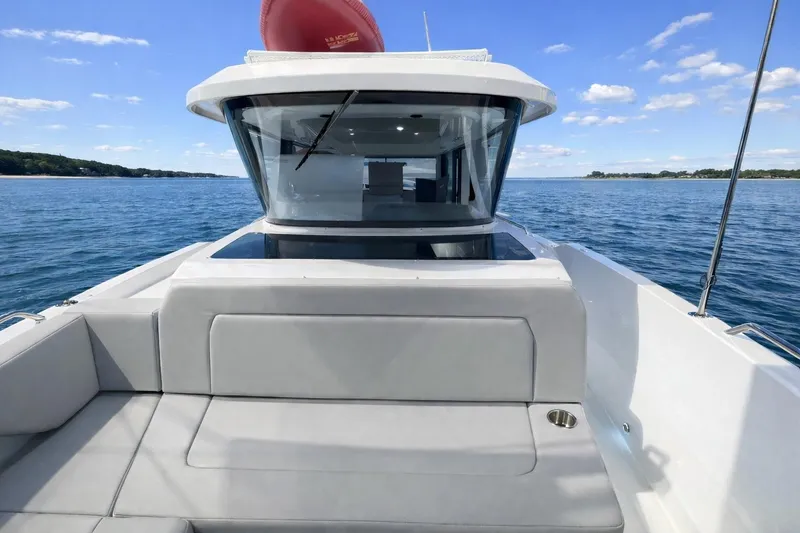 Slide: The Image of 2026 Cruisers Yachts 38 VTR on calm blue water, showcasing sleek design and spacious deck. - 17